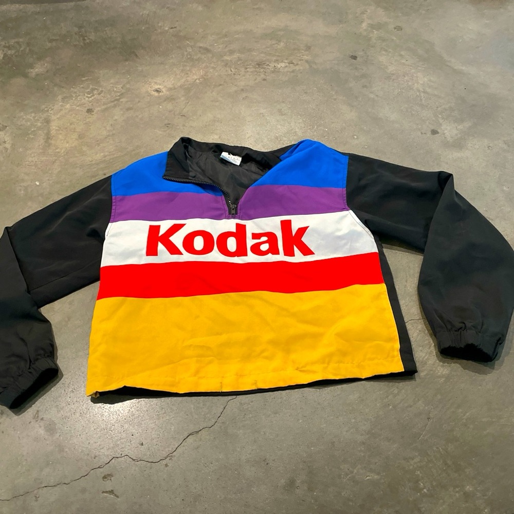 Striped Kodak windbreaker with front pockets.